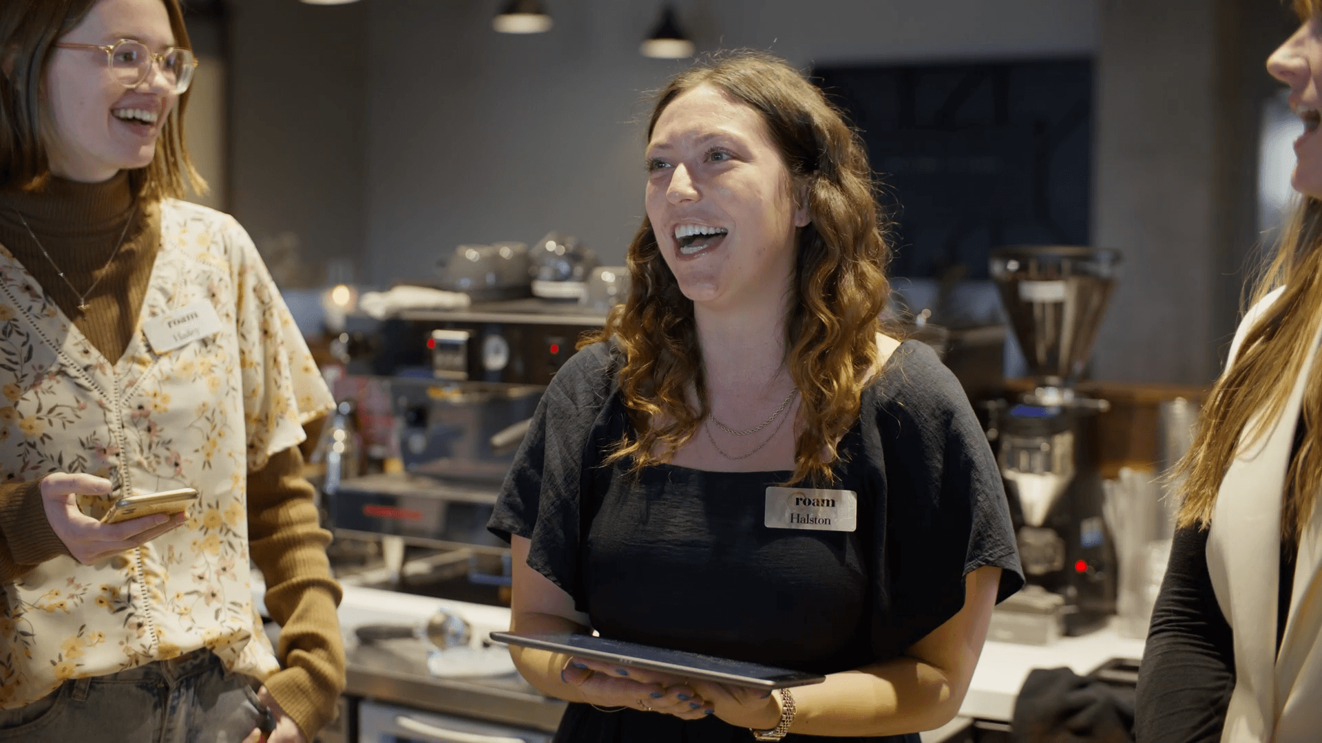 A Roam employee leading a team meeting with Basewell pulled up on an iPad