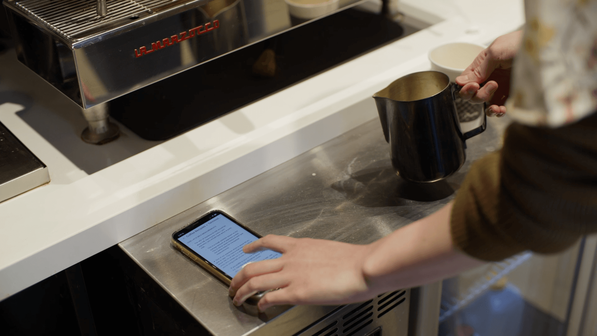 A Roam employee using Basewell to verify a new holiday coffee recipe at the Roam coffee bar